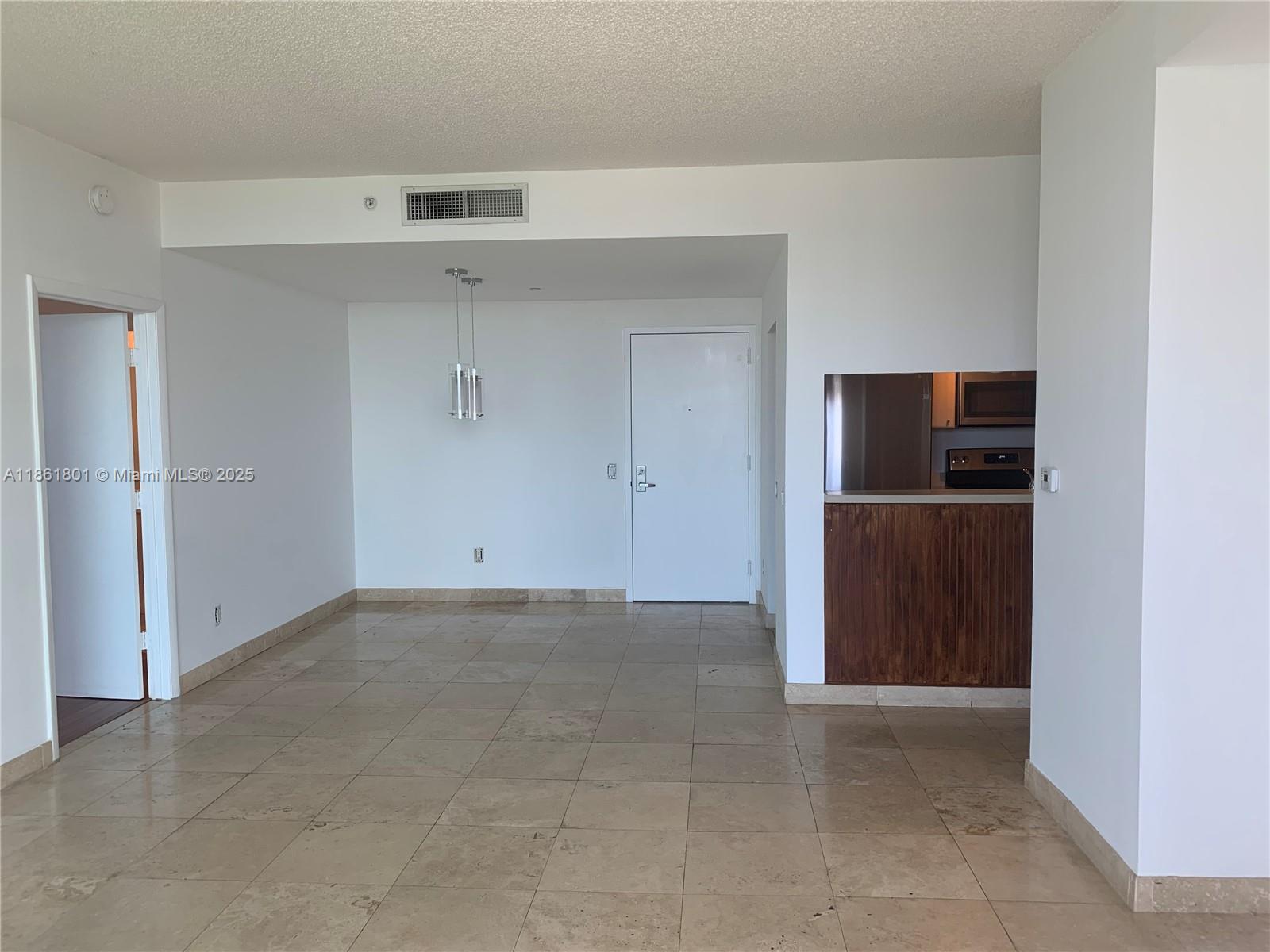 2475 Brickell Avenue, Unit 2504 Miami, FL 33129 - Photo 26 of 32 a view of kitchen with refrigerator and white cabinets