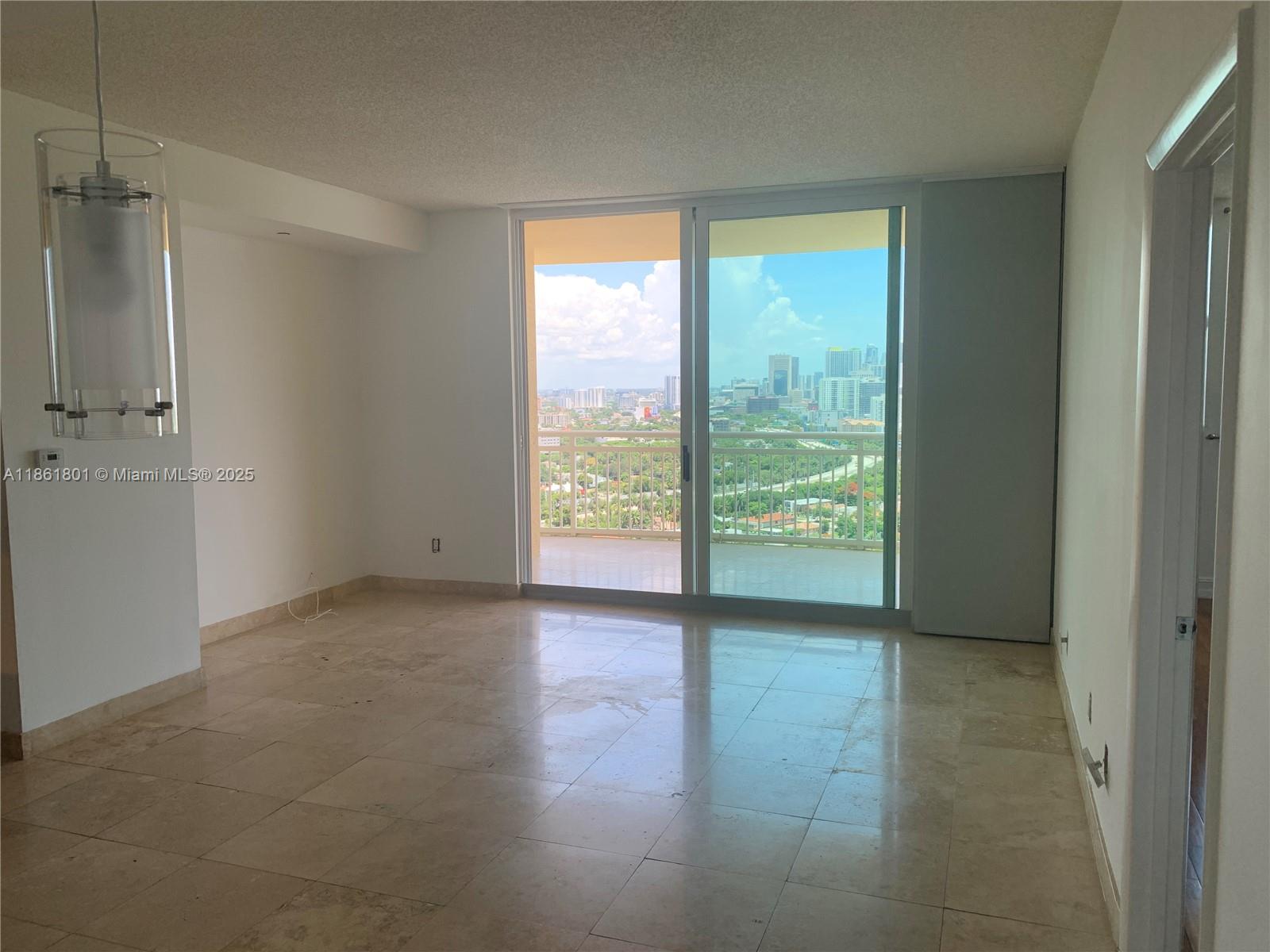2475 Brickell Avenue, Unit 2504 Miami, FL 33129 - Photo 27 of 32 a view of an empty room with glass door