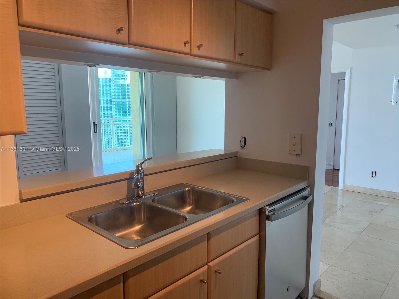 2475 Brickell Avenue, Unit 2504 Miami, FL 33129 - Photo 28 of 32 a kitchen with a sink and cabinets
