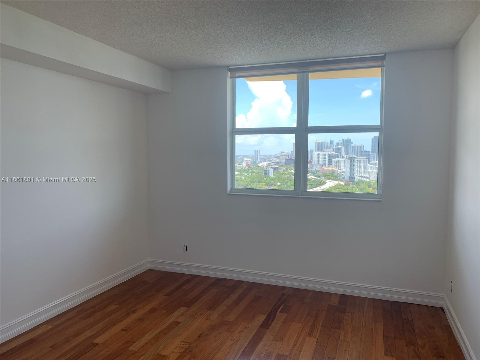 2475 Brickell Avenue, Unit 2504 Miami, FL 33129 - Photo 29 of 32 an empty room with a window