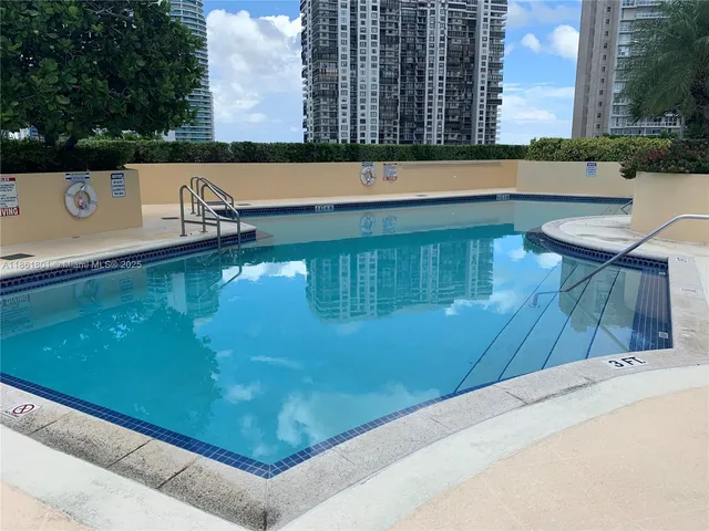 a view of a swimming pool with a chair and tables