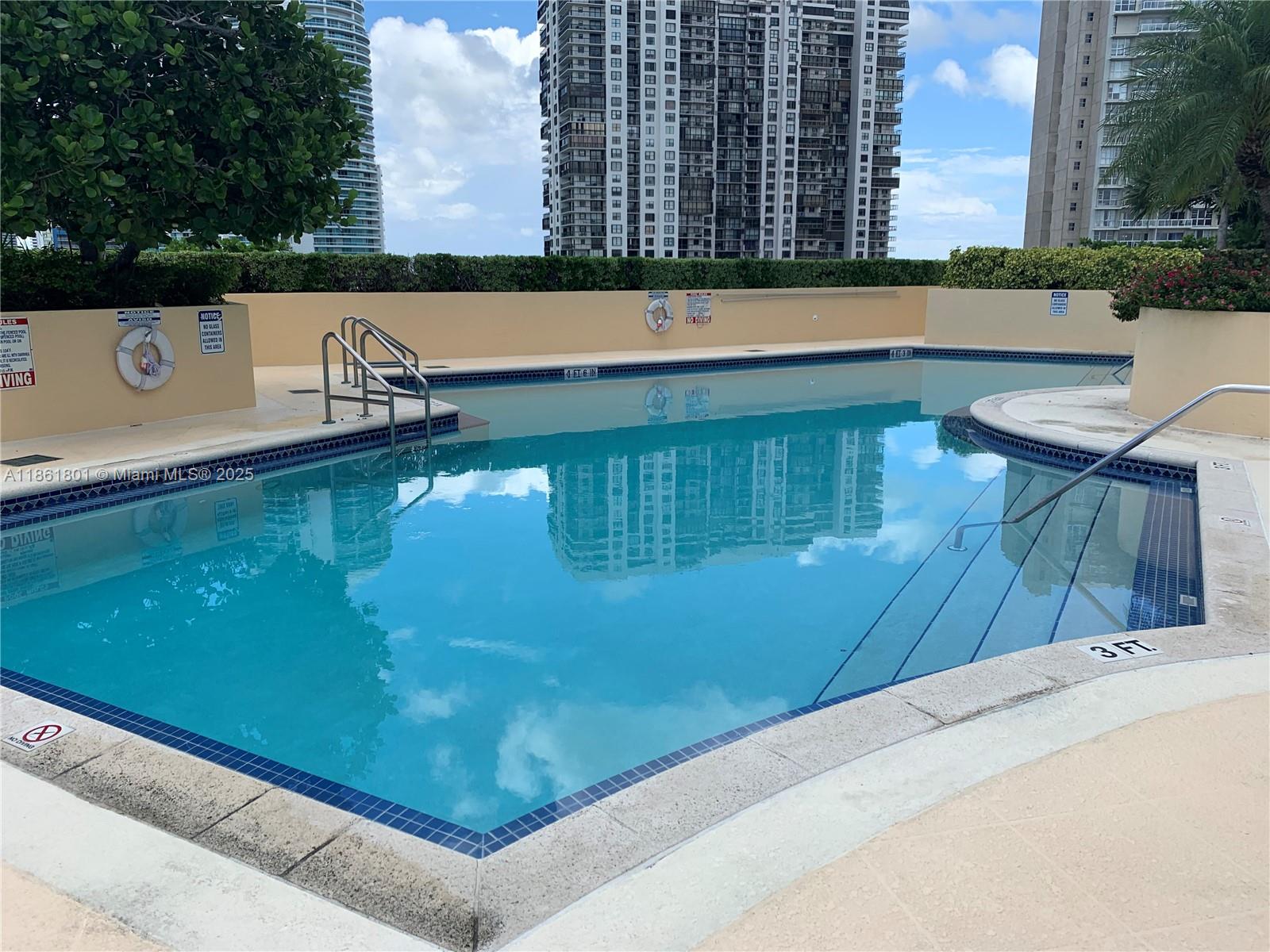 2475 Brickell Avenue, Unit 2504 Miami, FL 33129 - Photo 7 of 32 a view of a swimming pool with a chair and tables