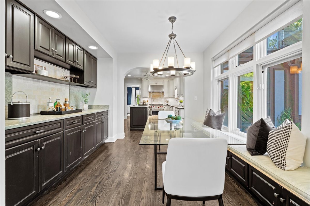 2951 Colfax Street Evanston, IL 60201 - Photo 23 of 62 a kitchen with stainless steel appliances kitchen island granite countertop a dining table chairs sink and cabinets