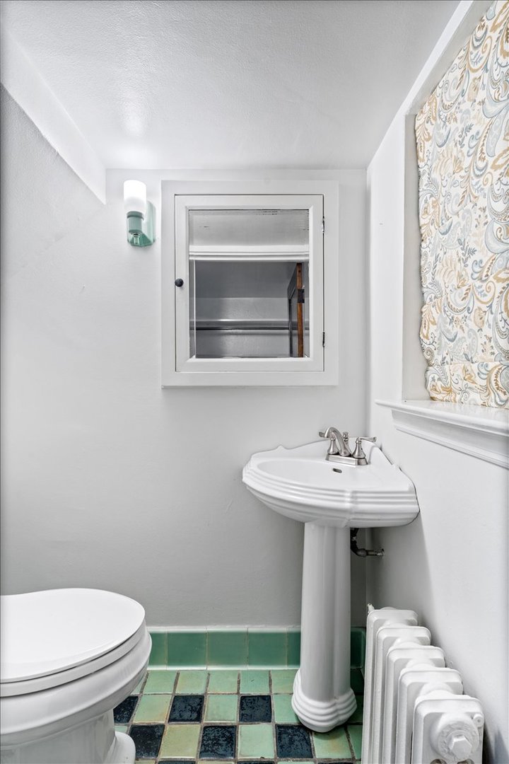 2951 Colfax Street Evanston, IL 60201 - Photo 29 of 62 a bathroom with a sink toilet and a window