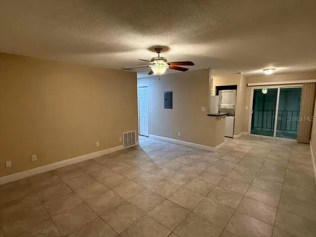 a view of a livingroom with a chandelier fan