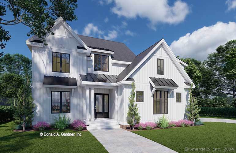 10 Metacomet Lane Suffield, CT 06093 - Photo 5 of 6 a front view of a house with a garden and plants