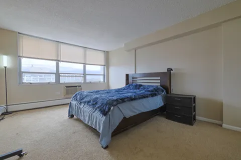 a bedroom with a bed and window