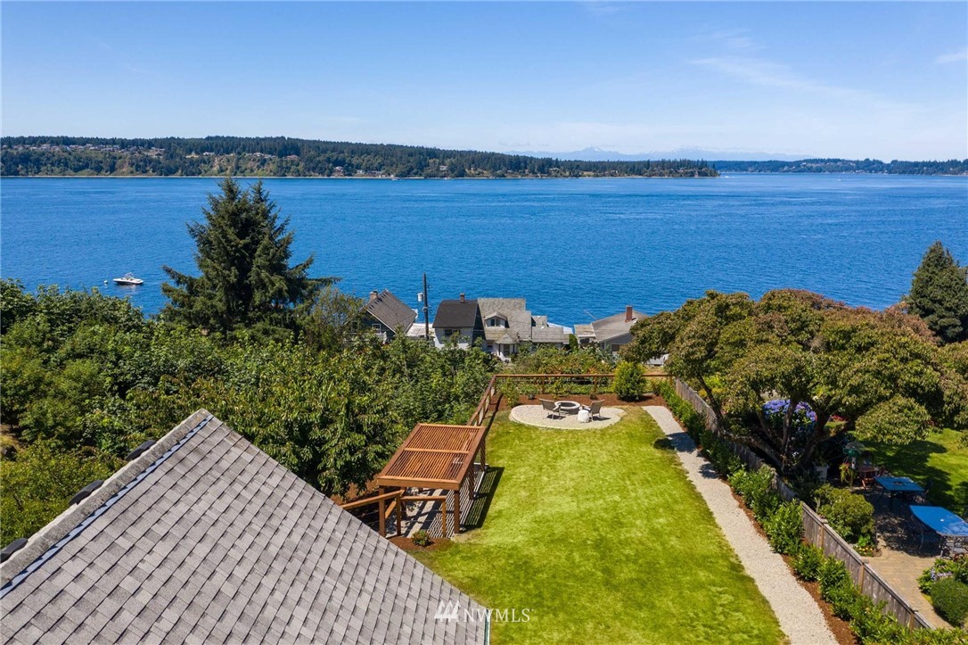 4411 Sunset Beach Road West University Place, WA 98466 - Photo 2 of 39 a view of a lake with a table and chairs