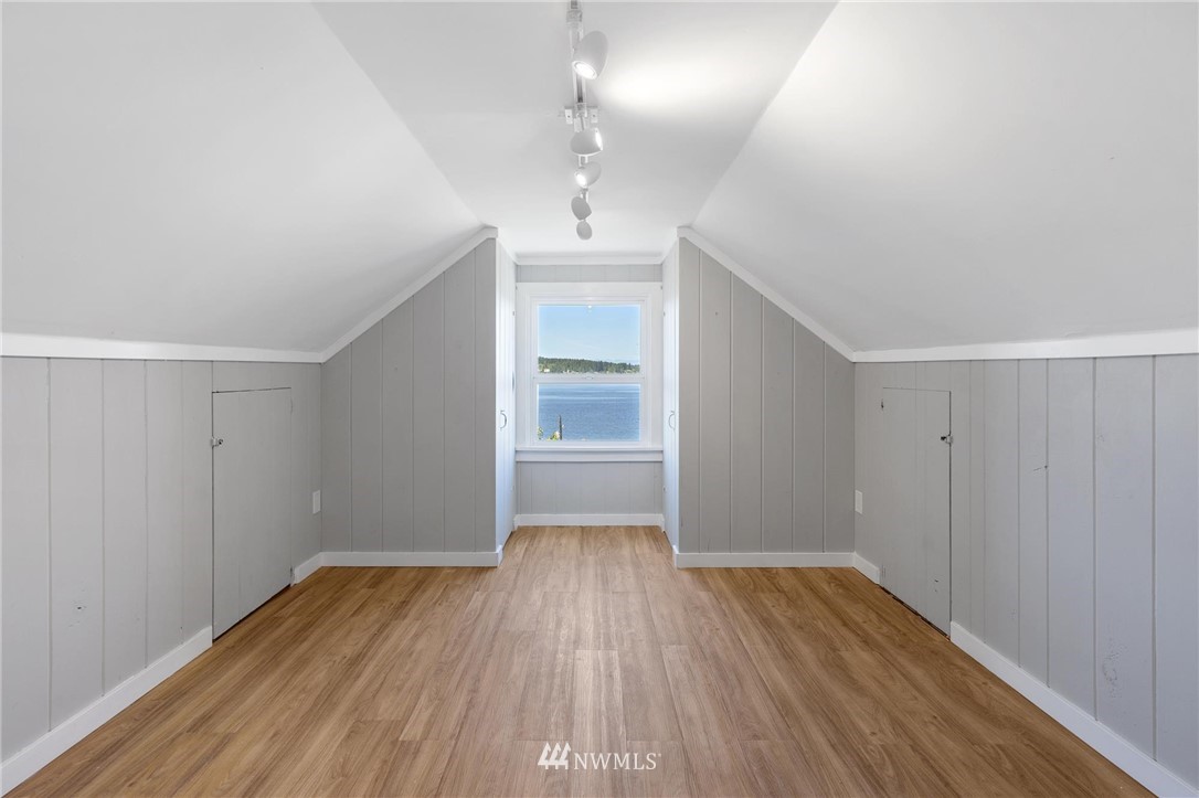 4411 Sunset Beach Road West University Place, WA 98466 - Photo 18 of 39 wooden floor in an empty room with a window