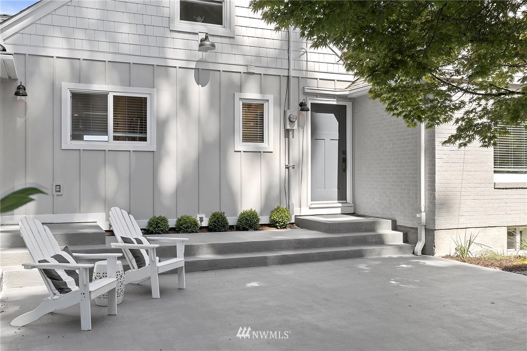 4411 Sunset Beach Road West University Place, WA 98466 - Photo 7 of 39 a front view of a house with outdoor seating and a potted plant