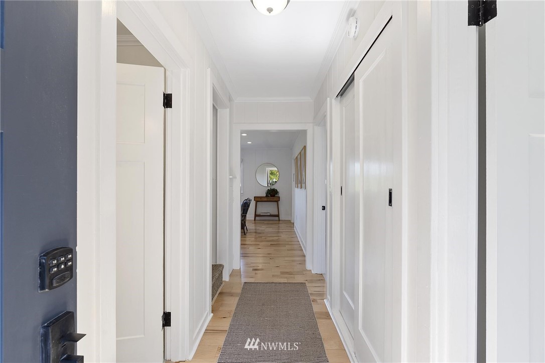 4411 Sunset Beach Road West University Place, WA 98466 - Photo 8 of 39 a view of a hallway with wooden floor and stairs
