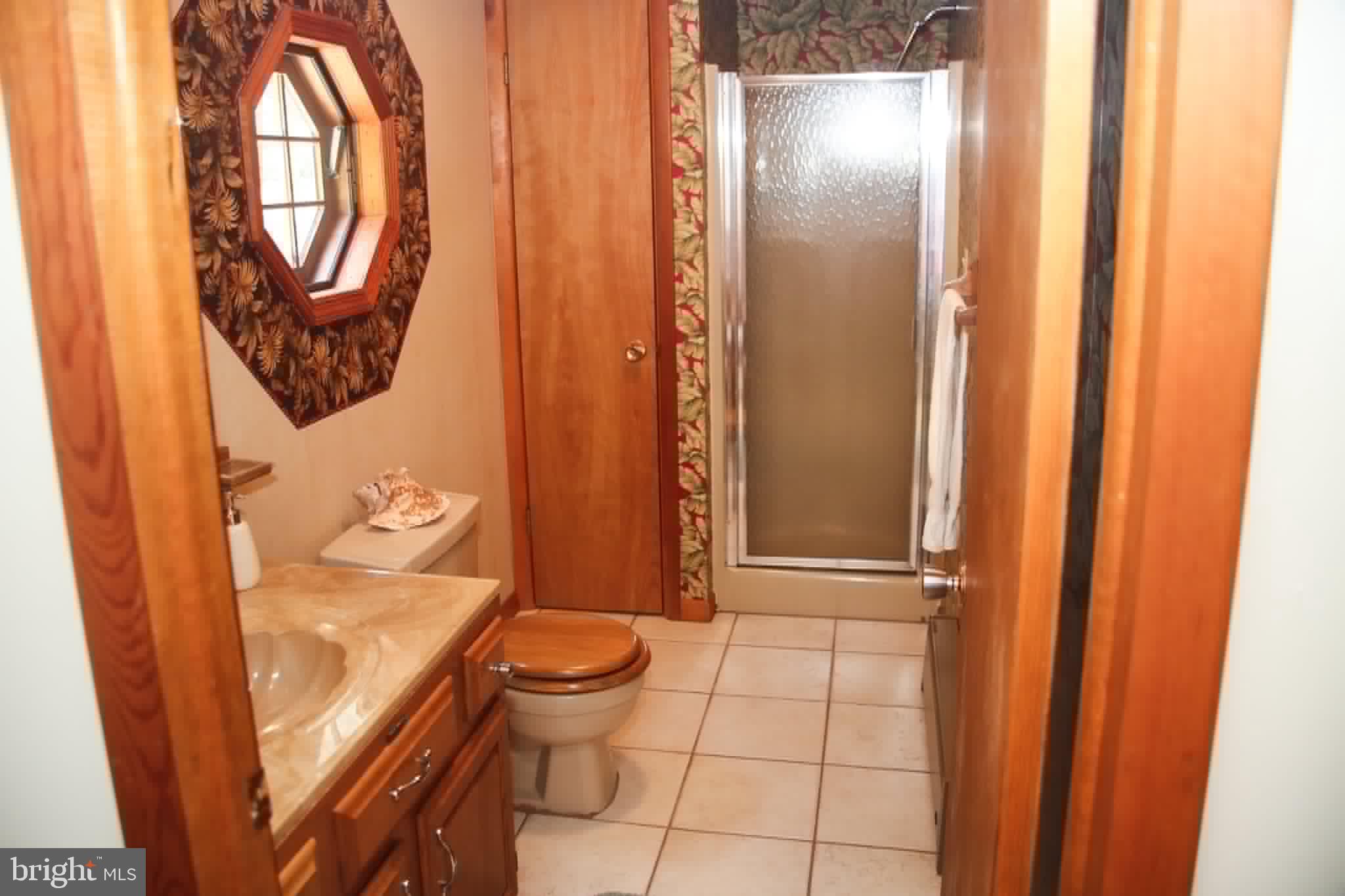 1740 Old Crellin Road Oakland, MD 21550 - Photo 19 of 28 a bathroom with a toilet and a shower curtain