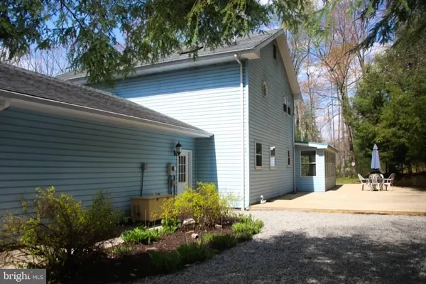 a front view of a house with a yard and outdoor seating