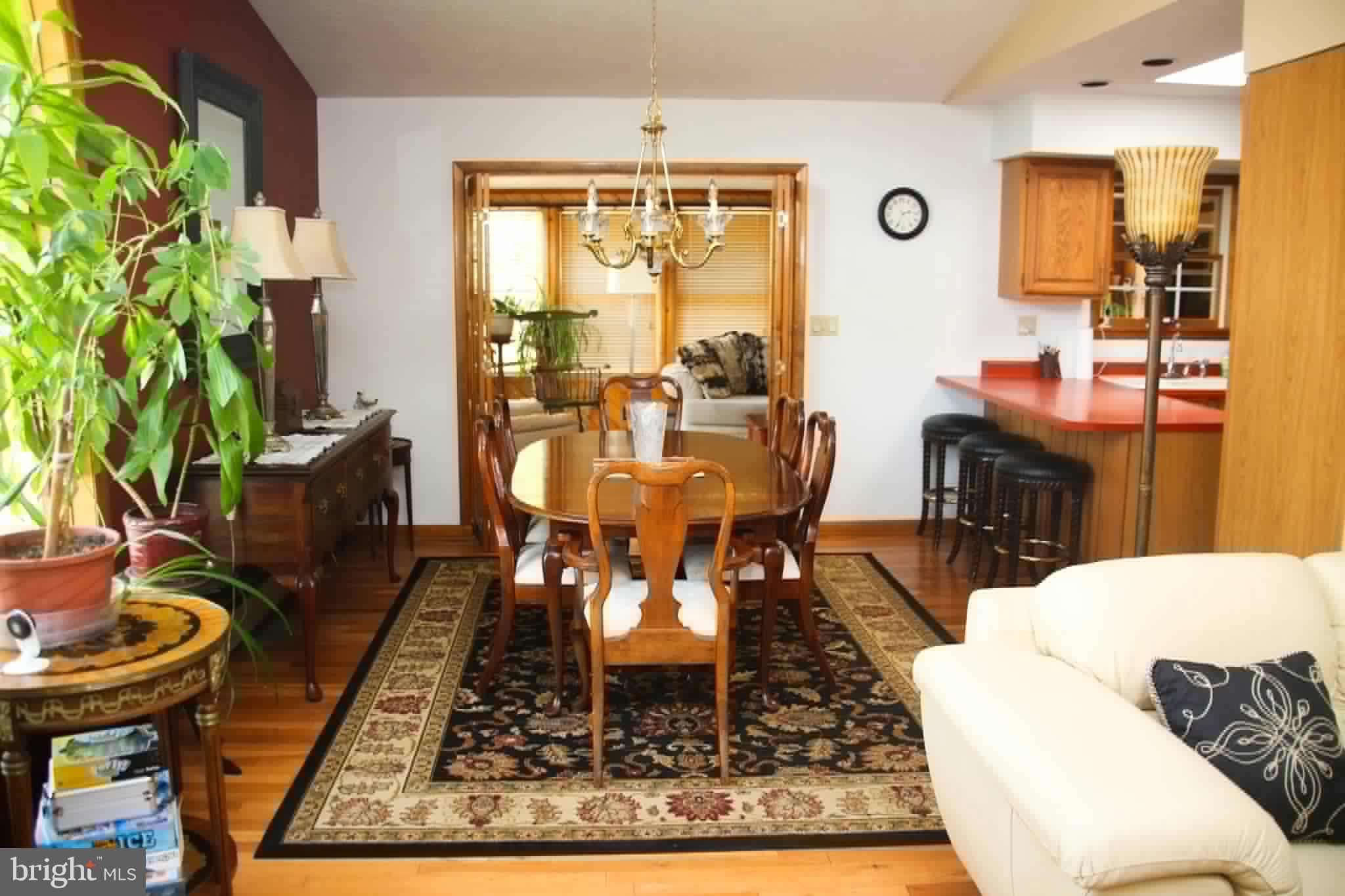 1740 Old Crellin Road Oakland, MD 21550 - Photo 7 of 28 a living room with a rug a dining table and a potted plant