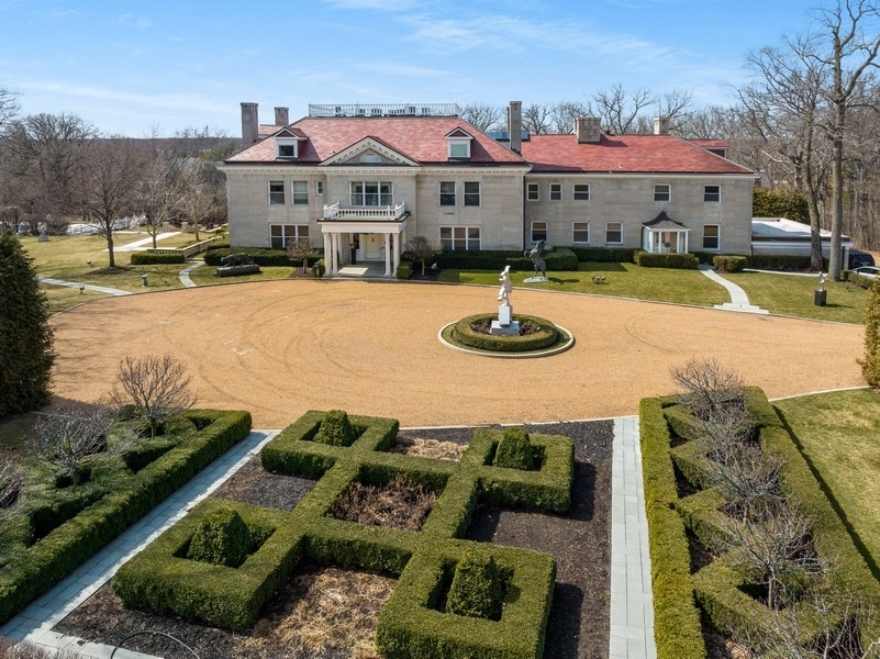 a front view of a house with garden and patio