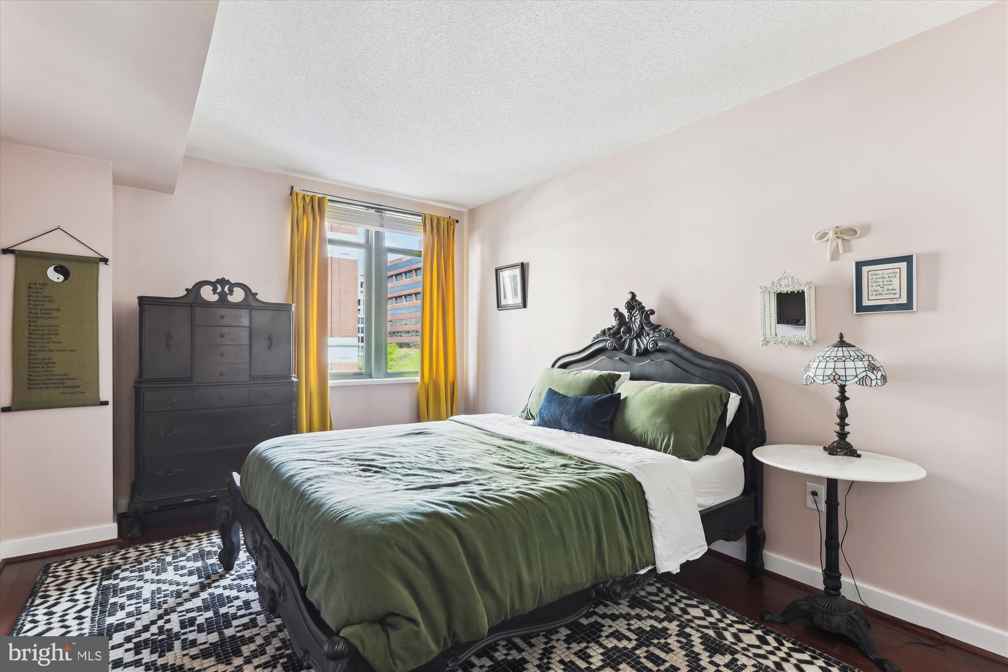 1150 K Street Northwest, Unit 706 Washington, DC 20005 - Photo 17 of 34 a bedroom with a bed and wooden floor