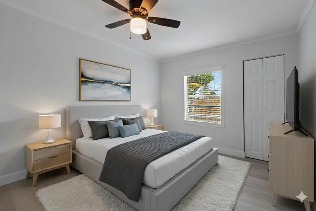 a bedroom with a bed and a flat screen tv