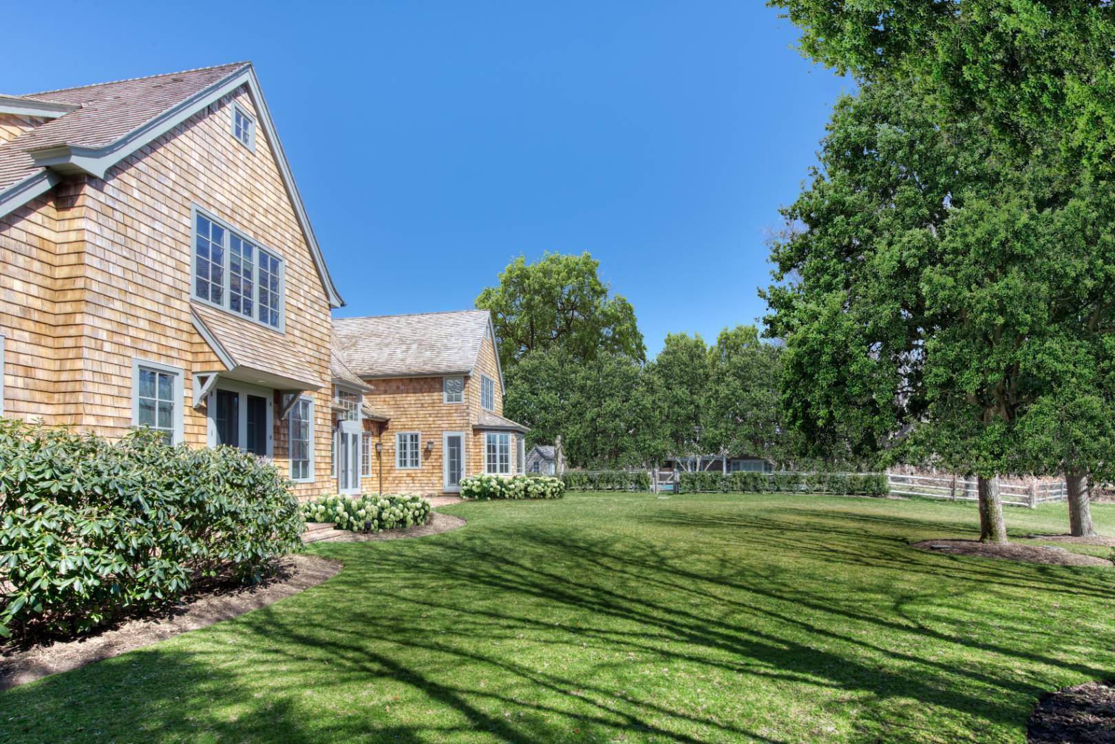 181 Parsonage Pond Road Sagaponack, NY 11962 - Photo 4 of 25 a front view of a house with a yard