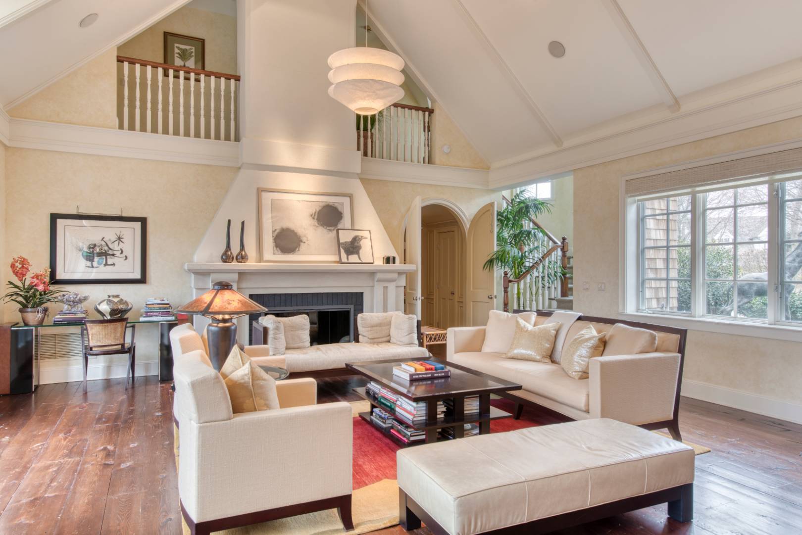 181 Parsonage Pond Road Sagaponack, NY 11962 - Photo 10 of 25 a living room with furniture a fireplace and a large window