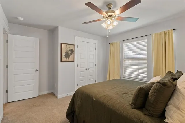 a bathroom with a sink a toilet and shower curtain
