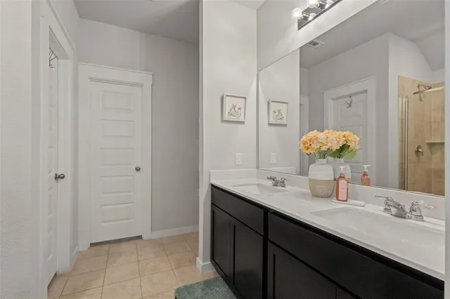 a bathroom with a shower and a sink