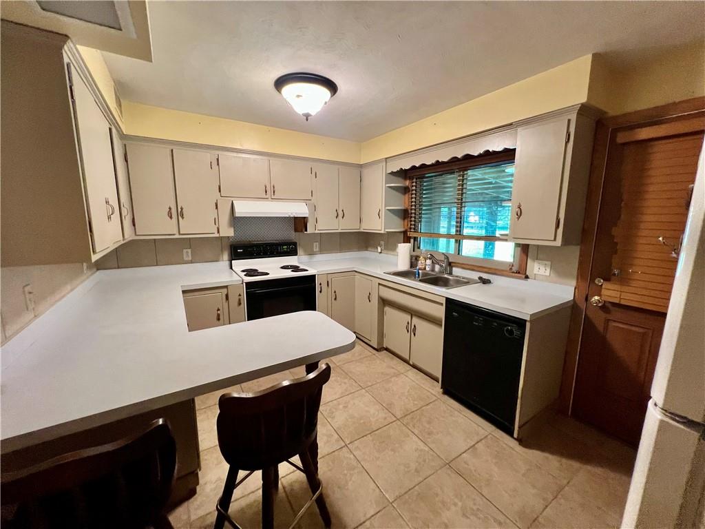 963 Kings Chapel Road New Castle, PA 16105 - Photo 14 of 27 a kitchen with a sink a stove a refrigerator and a stove