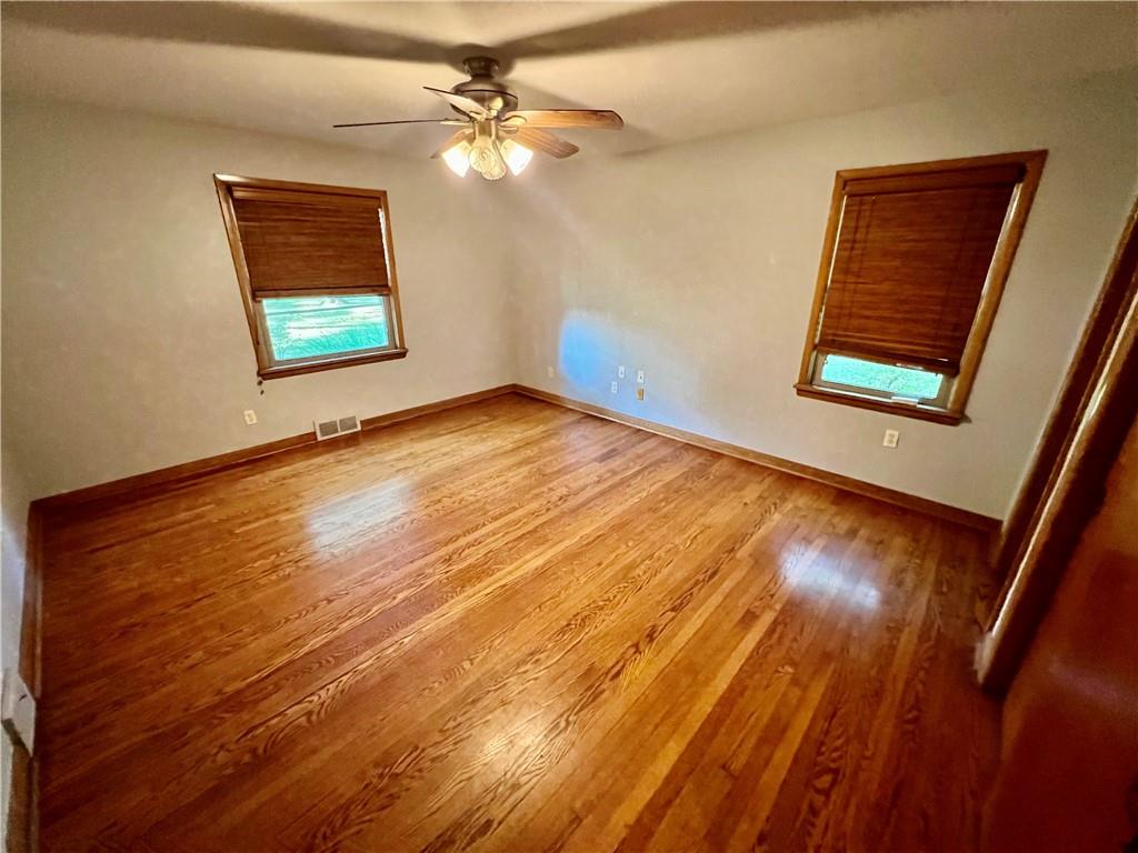963 Kings Chapel Road New Castle, PA 16105 - Photo 21 of 27 a view of an empty room with wooden floor and a window