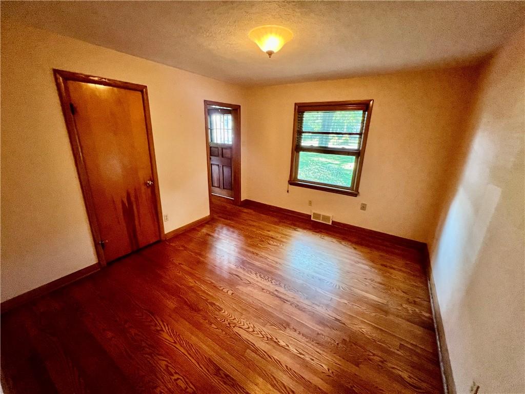 963 Kings Chapel Road New Castle, PA 16105 - Photo 23 of 27 a view of an empty room with wooden floor and a window