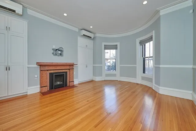 wooden floor fireplace and windows in a room