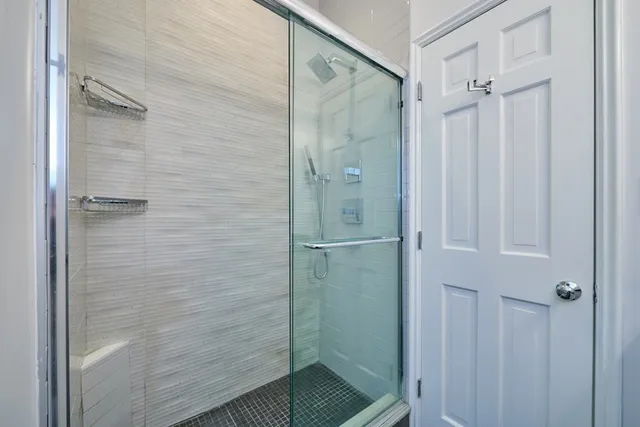 a bathroom with a glass shower door
