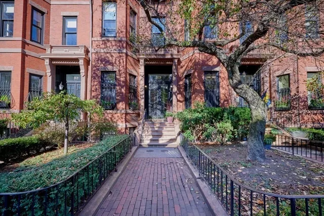 a view of a house with brick walls
