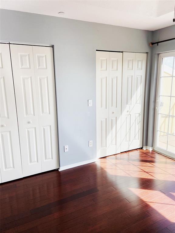 8946 White Sage Loop Lakewood Ranch, FL 34202 - Photo 17 of 36 a view of an empty room with wooden floor and a window