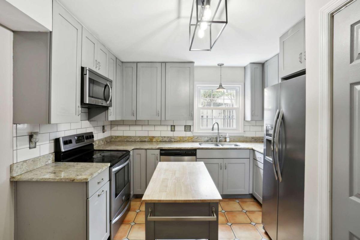 a kitchen with stainless steel appliances a stove sink refrigerator and microwave
