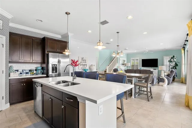 a kitchen with a sink a counter top space and stainless steel appliances