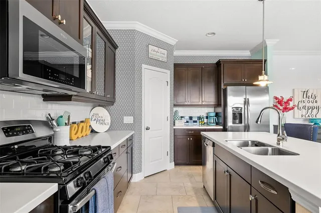 a kitchen that has a sink and a stove top oven
