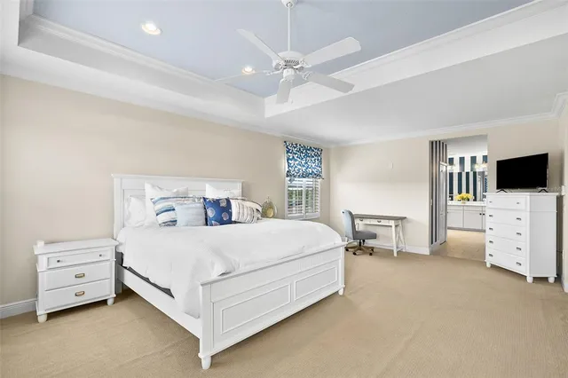 a bedroom with a bed and a flat tv screen on dresser