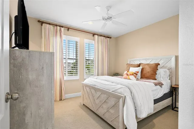a bedroom with a large bed and a chandelier
