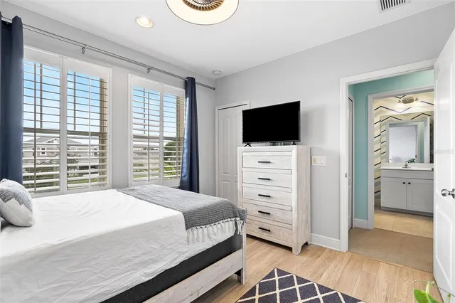 a bedroom with a bed and a television