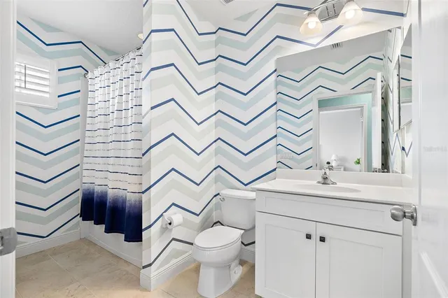 a bathroom with a sink toilet and a mirror