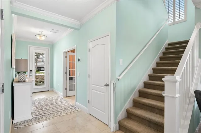 a view of an entryway with wooden floor and a livingroom view