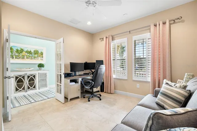 a livingroom with workspace and a window