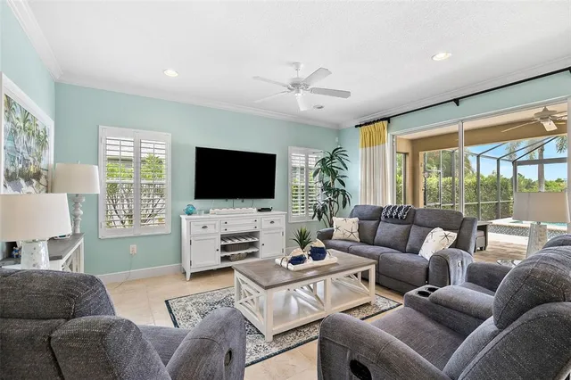 a living room with furniture a large window and a flat screen tv