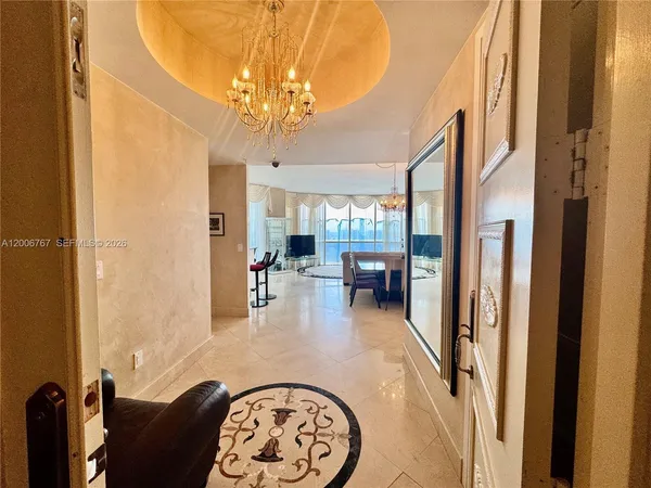a living room with furniture and a chandelier