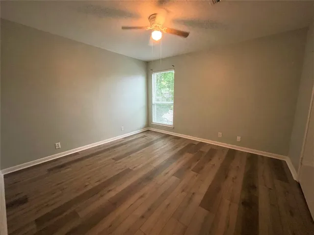 a view of a backyard with a large tree