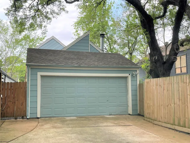 a view of a hallway with dining area chandelier and refrigerator