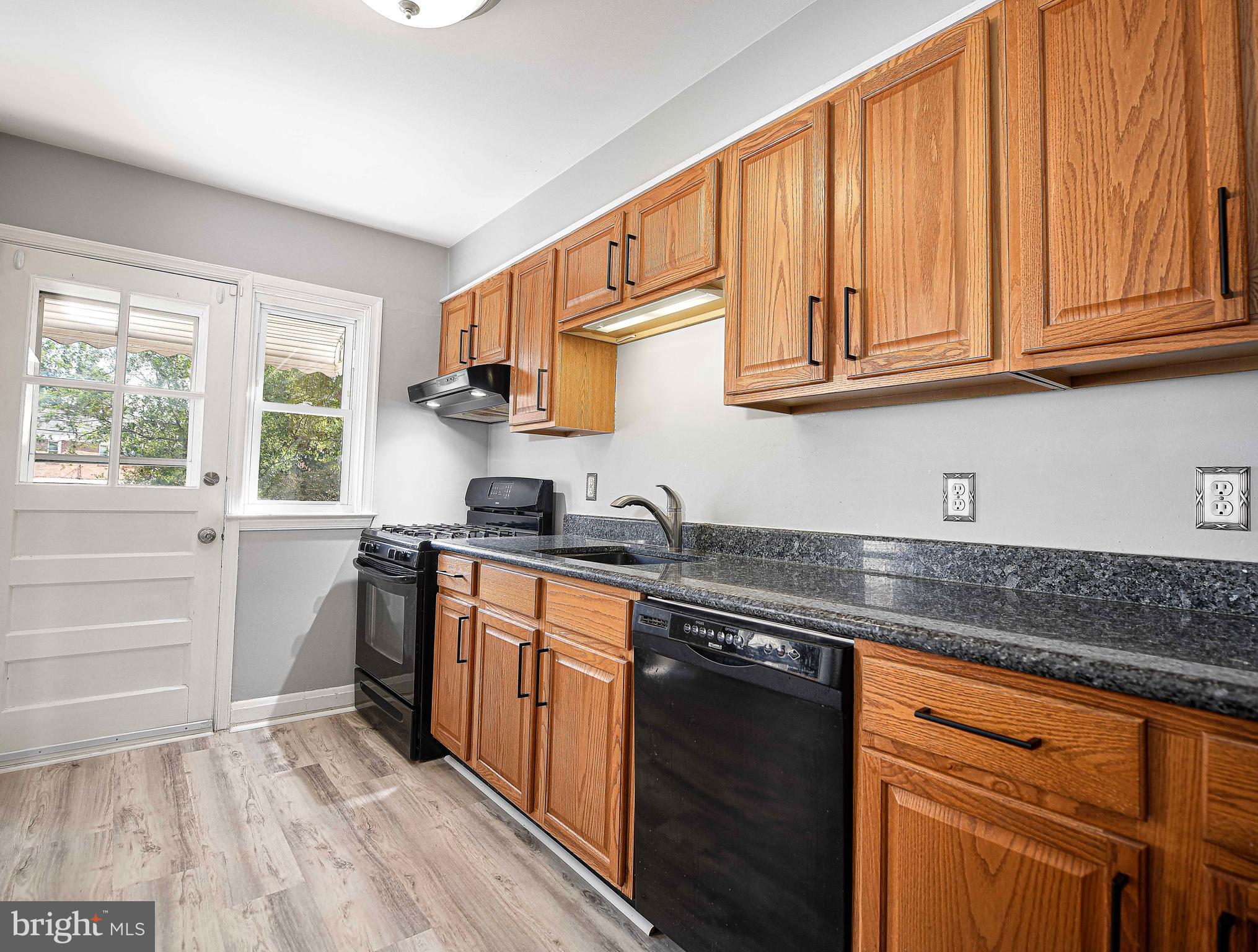 967 Radcliffe Road Baltimore, MD 21204 - Photo 11 of 26 a kitchen with stainless steel appliances granite countertop a sink stove and cabinets