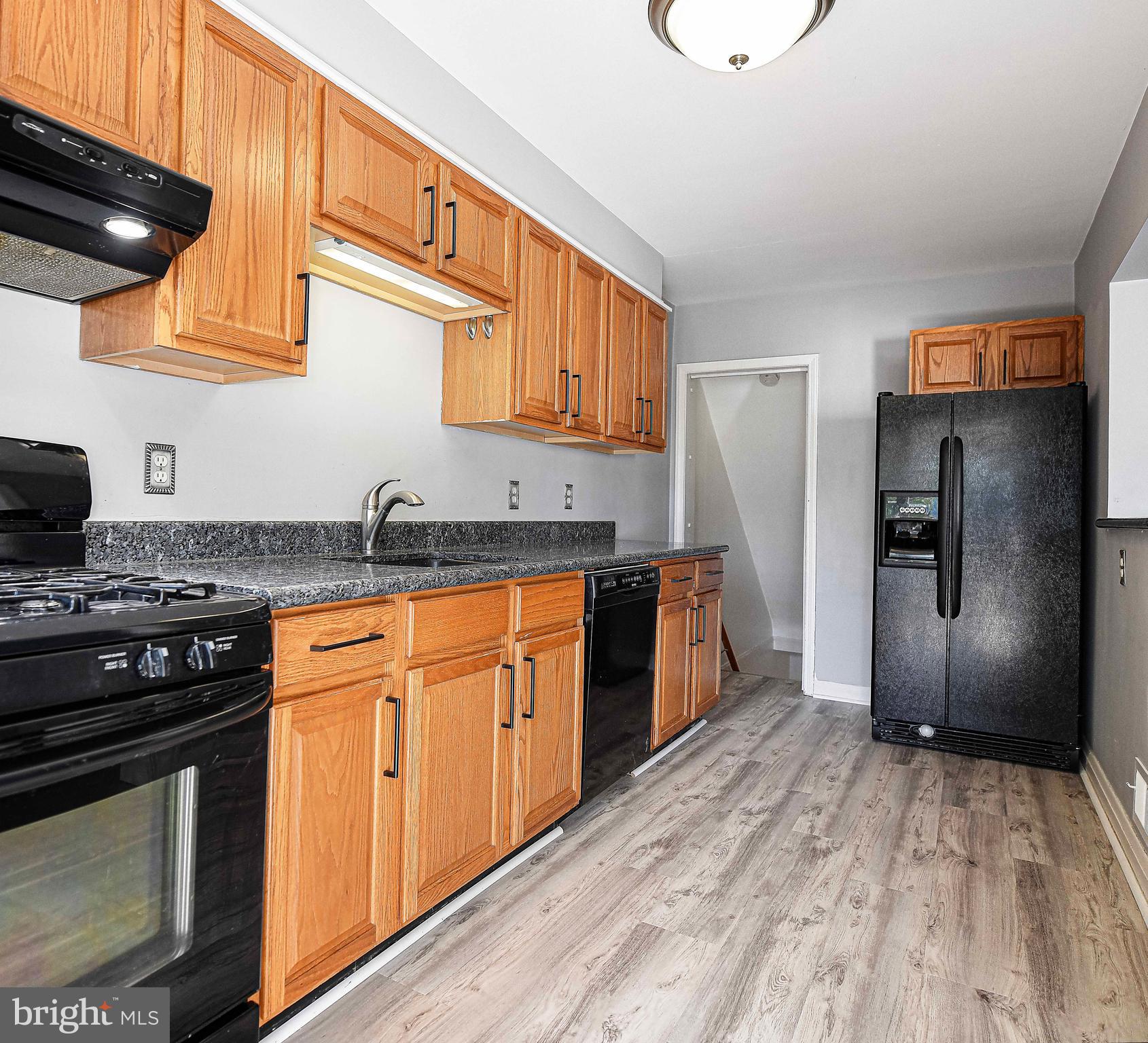967 Radcliffe Road Baltimore, MD 21204 - Photo 13 of 26 a kitchen with stainless steel appliances granite countertop a stove a sink and a refrigerator