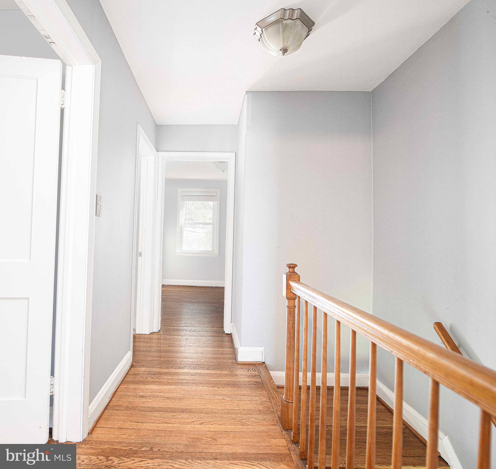 967 Radcliffe Road Baltimore, MD 21204 - Photo 14 of 26 a view of a hallway with wooden floor and staircase
