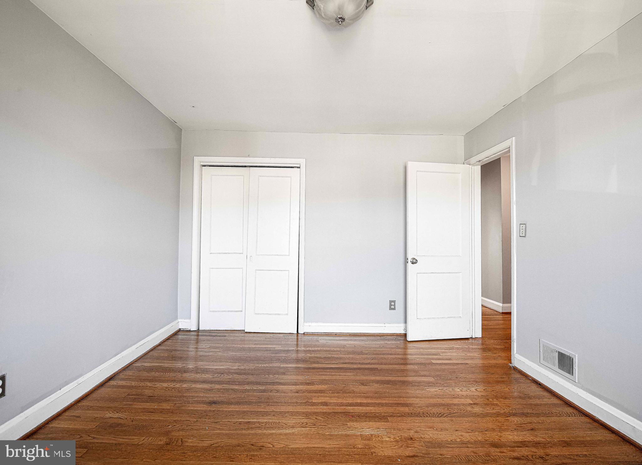 967 Radcliffe Road Baltimore, MD 21204 - Photo 15 of 26 a view of an empty room with wooden floor and closet