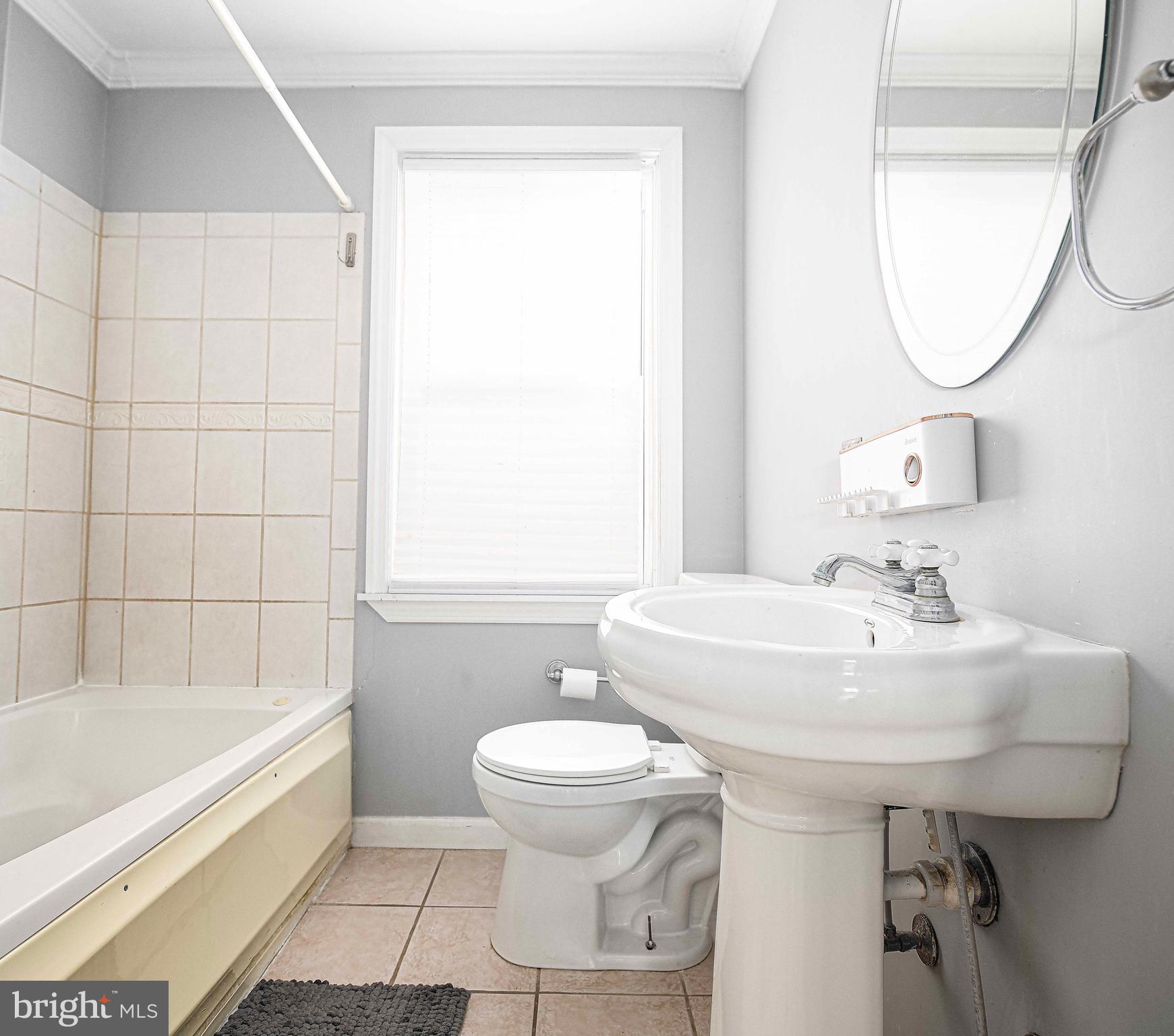 967 Radcliffe Road Baltimore, MD 21204 - Photo 19 of 26 a bathroom with a sink a toilet and a mirror